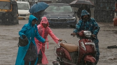 Children push their father's scooter through a flooded street as it rains in Mumbai, India, Thursday, July 25, 2024. (AP) Children push their father's scooter through a flooded street as it rains in Mumbai, India, Thursday, July 25, 2024. (AP)