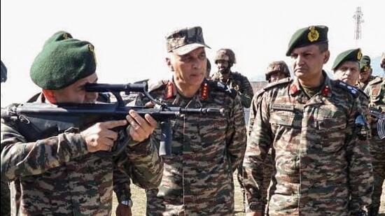 Chief of army staff General Upendra Dwivedi checks a weapon during his visit to the forward locations along the LoC. (ANI)