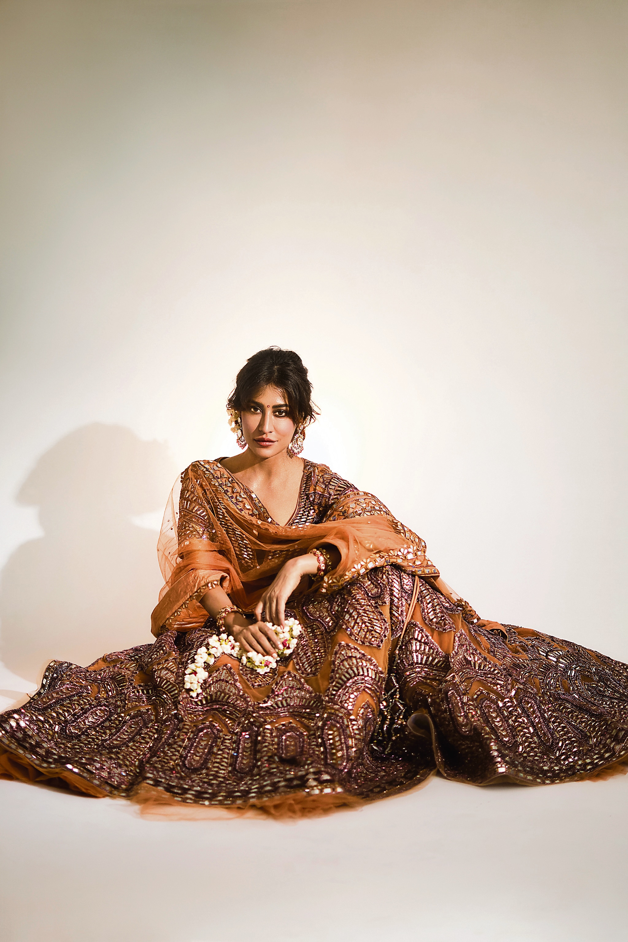 Chitrangda looks enchanting in a brown lehenga with mirror work as well as aari and dabka embroidery. Paired with a short choli from Mynah by Reynu Taandon, the playful patterns make it a fun bridal piece for any function. The look has been styled with polki and diamond earrings from Shree Jee Jewellers Jaipur. Beaded with pink tourmalines, they are inspired by both Mughal-era and art deco styles. The designer and the jeweller are participating in the FDCI Manifest Wedding Weekend on August 3 and 4, at Taj Palace Hotel, New Delhi (Vidhi Godha)