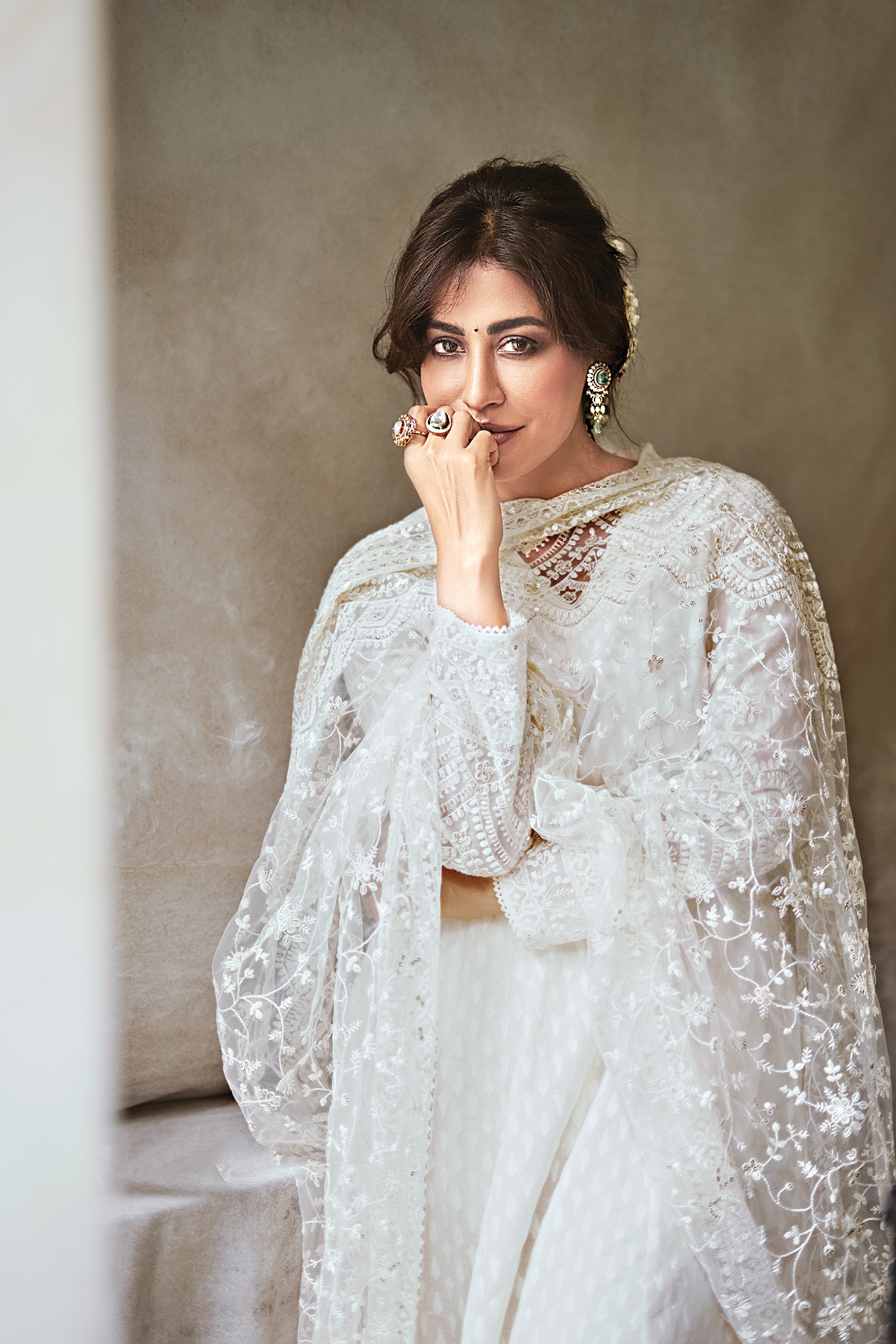 Actor Chitrangda Singh looks ethereal in this white anarkali with a heavily embroidered net dupatta featuring tassels, from W. Her look has been styled with polki diamond earrings with Russian emerald and rings from Tvisha Jewlz by Himanshu Khunteta(Vidhi Godha)