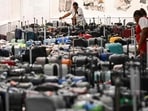 A customer looks through rows of bags awaiting reunification with their owners in the Delta Air Lines baggage claim area Los Angeles International Airport (LAX). A customer looks through rows of bags awaiting reunification with their owners in the Delta Air Lines baggage claim area Los Angeles International Airport (LAX).