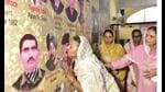 A family member shows affection to a photo of a fallen soldier during an event to mark the 25th anniversary of the Kargil Vijay Diwas in Jalandhar on Friday. (PTI) A family member shows affection to a photo of a fallen soldier during an event to mark the 25th anniversary of the Kargil Vijay Diwas in Jalandhar on Friday. (PTI)