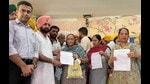 Officials handing over the letters for old-age pension to beneficiaries during the camp at Sahnewal. (HT File) Officials handing over the letters for old-age pension to beneficiaries during the camp at Sahnewal. (HT File)