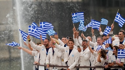 Team Greece waves flags in Paris, France, during the opening ceremony of the 2024 Summer Olympics, Friday, July 26, 2024. AP/PTI(AP07_26_2024_000513B) (AP) Team Greece waves flags in Paris, France, during the opening ceremony of the 2024 Summer Olympics, Friday, July 26, 2024. AP/PTI(AP07_26_2024_000513B) (AP)