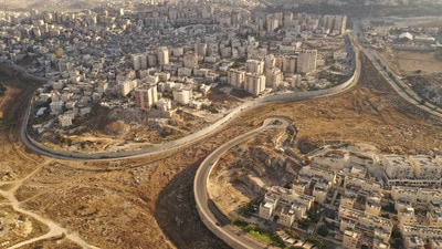 Aerial view of Israel and Palestine divided by a security wall. (Shutterstock) Aerial view of Israel and Palestine divided by a security wall. (Shutterstock)