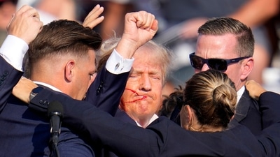 Republican presidential candidate former President Donald Trump is helped off the stage by U.S. Secret Service agents at a campaign event in Butler, Pa., on Saturday, July 13, 2024. (AP Photo/Gene J. Puskar) (AP) Republican presidential candidate former President Donald Trump is helped off the stage by U.S. Secret Service agents at a campaign event in Butler, Pa., on Saturday, July 13, 2024. (AP Photo/Gene J. Puskar) (AP)