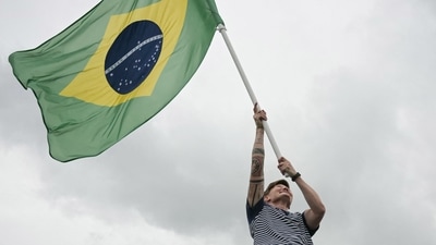 Brazil's flag bearer Raquel Cristina Kochhann is lifted up by fellow Rugby Sevens players as Brazil's delegation sails in a boat along the river Seine during the opening ceremony of the Paris 2024 Olympic Games in Paris on July 26, 2024. (AFP) Brazil's flag bearer Raquel Cristina Kochhann is lifted up by fellow Rugby Sevens players as Brazil's delegation sails in a boat along the river Seine during the opening ceremony of the Paris 2024 Olympic Games in Paris on July 26, 2024. (AFP)