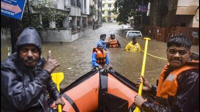 Officials during a rescue operation in a waterlogged area in Pune on Thursday. (PTI) Officials during a rescue operation in a waterlogged area in Pune on Thursday. (PTI)