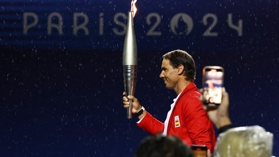 Rafael Nadal, of Spain, carries the torch during the opening ceremony of the 2024 Summer Olympics, Friday, July 26, 2024 in Paris, France. (Stephanie Lecocq/Pool Photo via AP) (AP) Rafael Nadal, of Spain, carries the torch during the opening ceremony of the 2024 Summer Olympics, Friday, July 26, 2024 in Paris, France. (Stephanie Lecocq/Pool Photo via AP) (AP)
