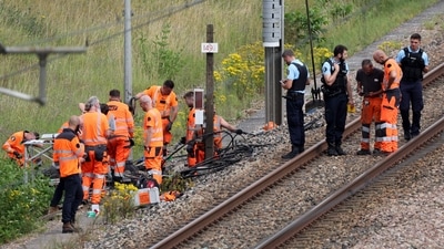 SNCF employees and French gendarmes inspect the scene of a suspected attack on the high speed railway network at Croiselles, northern France on July 26, 2024. French security forces are hunting people behind arson attacks that hobbled the country's high-speed rail network hours before the Olympic Games opening ceremony, Prime Minister Gabriel Attal said. (Photo by Denis CHARLET / AFP) SNCF employees and French gendarmes inspect the scene of a suspected attack on the high speed railway network at Croiselles, northern France on July 26, 2024. French security forces are hunting people behind arson attacks that hobbled the country's high-speed rail network hours before the Olympic Games opening ceremony, Prime Minister Gabriel Attal said. (Photo by Denis CHARLET / AFP)