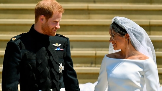 Prince Harry and Meghan Markle walk down the steps after their wedding.(AP)