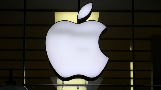 The Apple logo is illuminated at a store.(AP)