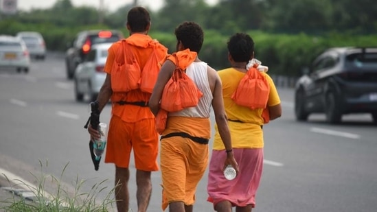 Kanwariyas carrying holy water collected from River Ganga in Haridwar walk back to their hometowns. (Parveen Kumar/ HT Photo)