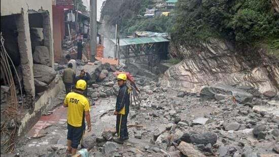 Officials said some vehicles were reported to have been buried in the debris after the rainfall. (HT photo)