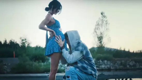 Megan Fox left fans puzzled after sporting a baby bump in Machine Gun Kelly's music video for Lonely Road(MGK/ YouTube)