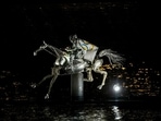 A performer on a mechanical horse carries the Olympic flag down the river Seine in Paris, France, during the opening ceremony of the 2024 Summer Olympics, Friday, July 26, 2024. (AP Photo/Lindsey Wasson) A performer on a mechanical horse carries the Olympic flag down the river Seine in Paris, France, during the opening ceremony of the 2024 Summer Olympics, Friday, July 26, 2024. (AP Photo/Lindsey Wasson)