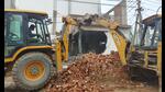 A Gurugram Metropolitan Development Authority (GMDA) team demolishes illegal constructions at Saraswati Kunj at Sector-53 near Golf Course Road in Gurugram on Saturday. (Parveen Kumar/HT PHOTO)