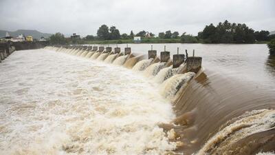 Krishna River overflows from Khodshi Dam after rains on Saturday. (PTI) Krishna River overflows from Khodshi Dam after rains on Saturday. (PTI)