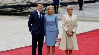 First lady Jill Biden welcomed by French President Emmanuel Macron and his wife Brigitte Macron at the Elysee Palace ahead of an opening ceremony. (AP)