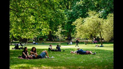 People sit on the grass in St James's park, in London, Tuesday, June 25, 2024, as the temperatures are set to reach 28C during the week. (AP Photo/Alberto Pezzali) (AP) People sit on the grass in St James's park, in London, Tuesday, June 25, 2024, as the temperatures are set to reach 28C during the week. (AP Photo/Alberto Pezzali) (AP)