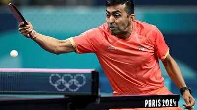 India's Harmeet Desai plays a return to Jordan's Zaid Abo Yaman during the men's table tennis singles preliminary round at the Paris 2024 Olympic Games (AFP)