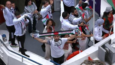 Team Palestine is seen on a boat on the River Seine during the opening ceremony. (Getty Images) Team Palestine is seen on a boat on the River Seine during the opening ceremony. (Getty Images)