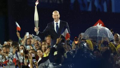 Zinedine Zidane, the French footballer, walked with the Olympic torch during the opening ceremony of the games (Twitter/@Paris2024)