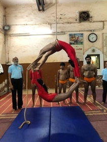 Anjali Tapal and Komal Patil, the mallakhamb performers forming a circle during a practice session with Uday Deshpande in the background (to the left) (Kiran Mehta) Anjali Tapal and Komal Patil, the mallakhamb performers forming a circle during a practice session with Uday Deshpande in the background (to the left) (Kiran Mehta)