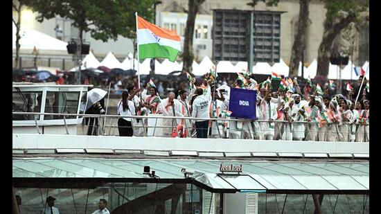 India's flag-bearers, PV Sindhu and Achanta Sharath Kamal, hold the tricolour as Team India's athletes' boat glides down the Seine. (Sukumaran)