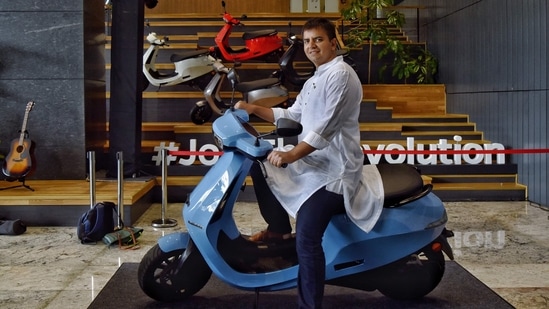 Bhavish Aggarwal, Co-founder and CEO of Ola, poses for a photograph with the new Ola electric scooter during its launch at the Ola headquarters in Bangalore on August 15, 2021. (AFP)