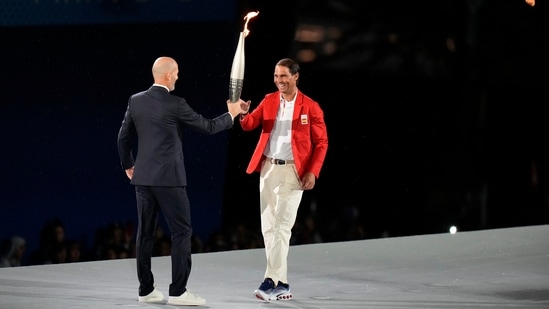 https://www.mobilemasala.com/sports/Zinedine-Zidane-passes-torch-to-Rafael-Nadal-during-star-studded-Paris-Olympics-2024-opening-ceremony-i284532