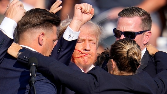 Republican presidential candidate former President Donald Trump is helped off the stage by U.S. Secret Service agents at a campaign event in Butler, Pa., on Saturday, July 13, 2024. (AP Photo/Gene J. Puskar)(AP)
