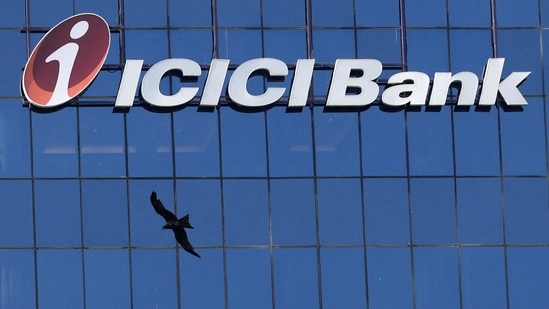 A bird flies past the facade of the ICICI bank head office in Mumbai (Reuters)