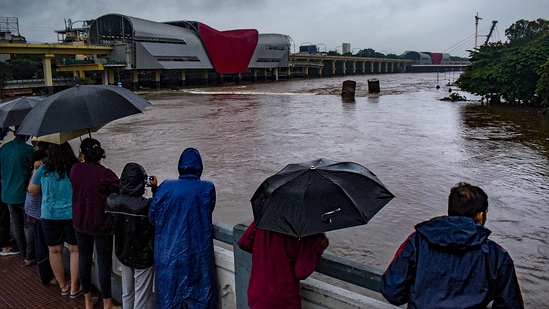 Pune: People watch an overflowing Mutha river following heavy rainfall, in Pune district, Thursday, July 25, 2024. (PTI)