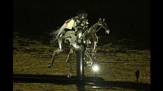 Floriane Issert, a Gendarmerie non-commissioned officer of the National Gendarmerie, rides on a metal horse up the Seine river, during the opening ceremony of the Paris 2024 Olympic Games. (AFP)