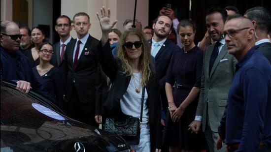 Canadian singer Celine Dion waves as she leaves Le Royal Monceau - Raffles Paris hotel. (REUTERS)