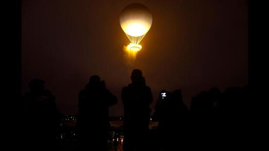 The cauldron, with the Olympic flame lit, lifts off while attached to a balloon during the opening ceremony of the Paris 2024 Olympic Games. (AFP)