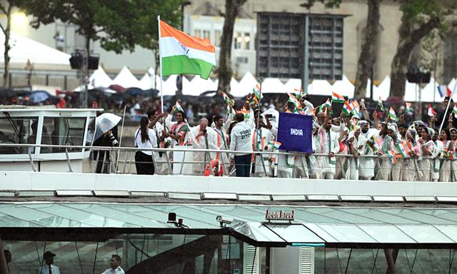 India's flag-bearers, PV Sindhu and Achanta Sharath Kamal, hold the tricolour as Team India's athletes' boat glides down the Seine. (Sukumaran) India's flag-bearers, PV Sindhu and Achanta Sharath Kamal, hold the tricolour as Team India's athletes' boat glides down the Seine. (Sukumaran)