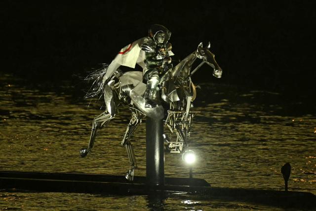 Floriane Issert, a Gendarmerie non-commissioned officer of the National Gendarmerie, rides on a metal horse up the Seine river, during the opening ceremony of the Paris 2024 Olympic Games. (AFP) Floriane Issert, a Gendarmerie non-commissioned officer of the National Gendarmerie, rides on a metal horse up the Seine river, during the opening ceremony of the Paris 2024 Olympic Games. (AFP)