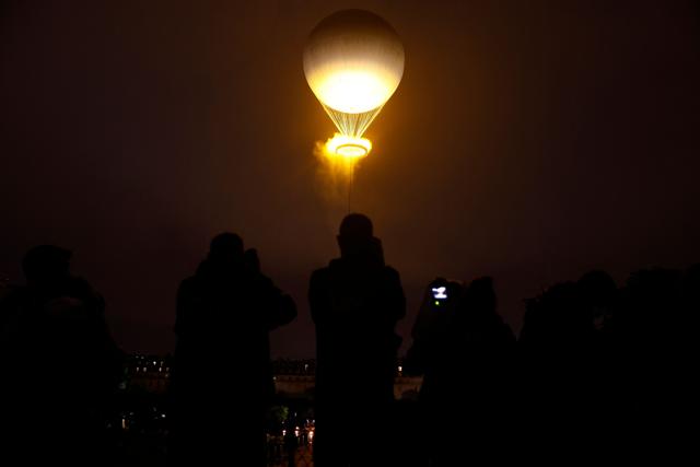 The cauldron, with the Olympic flame lit, lifts off while attached to a balloon during the opening ceremony of the Paris 2024 Olympic Games. (AFP) The cauldron, with the Olympic flame lit, lifts off while attached to a balloon during the opening ceremony of the Paris 2024 Olympic Games. (AFP)