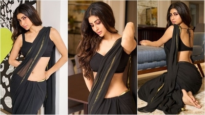 Mouni Roy is an absolute stunner who consistently nails fashion goals like a pro. Whether it's a mini dress or a red-carpet-worthy gown, she can flawlessly rock any look. Known for her bold dressing sense, she set aside her usual bikini and bodycon styles this time to embrace ethnic elegance in a simple black saree, exuding class and sophistication. (Instagram/@imouniroy) Mouni Roy is an absolute stunner who consistently nails fashion goals like a pro. Whether it's a mini dress or a red-carpet-worthy gown, she can flawlessly rock any look. Known for her bold dressing sense, she set aside her usual bikini and bodycon styles this time to embrace ethnic elegance in a simple black saree, exuding class and sophistication. (Instagram/@imouniroy)