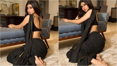 Her saree is a mesmerising shade of black with a gold border all around. She draped the saree in a traditional manner with the pallu falling elegantly from the shoulders. (Instagram/@imouniroy) Her saree is a mesmerising shade of black with a gold border all around. She draped the saree in a traditional manner with the pallu falling elegantly from the shoulders. (Instagram/@imouniroy)