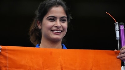 Manu Bhaker holds India flag after winning bronze in the 10m air pistol event in Paris. (REUTERS)
