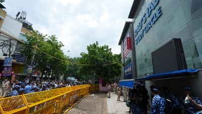 Security personnel stand guard near a UPSC exam coaching centre after three civil services aspirants died when the basement of the coaching centre was flooded by rainwater, (PTI) (PTI)