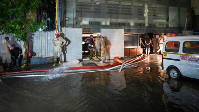 Rescue workers pump out water from the basement on Sunday. (Sanchit Khanna/HT Photo) Rescue workers pump out water from the basement on Sunday. (Sanchit Khanna/HT Photo)