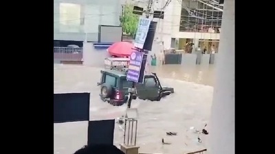 After an SUV passes the road, water hits the gate of the coaching institute, and the gates break as it is unable to withstand the pressure of flood waters. (@htTweets ) After an SUV passes the road, water hits the gate of the coaching institute, and the gates break as it is unable to withstand the pressure of flood waters. (@htTweets )