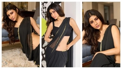 Mouni Roy radiated a sensuous vibe in a gorgeous black saree with a golden border. She paired the black saree with a black sleeveless crop blouse and a matching bindi and let her hair cascade down her back in soft curls. The actor didn't go for any accessories, making her black ensemble do all the talking over blings and trinkets. (Instagram/@imouniroy) Mouni Roy radiated a sensuous vibe in a gorgeous black saree with a golden border. She paired the black saree with a black sleeveless crop blouse and a matching bindi and let her hair cascade down her back in soft curls. The actor didn't go for any accessories, making her black ensemble do all the talking over blings and trinkets. (Instagram/@imouniroy)