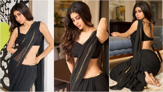 Mouni Roy is an absolute stunner who consistently nails fashion goals like a pro. Whether it's a mini dress or a red-carpet-worthy gown, she can flawlessly rock any look. Known for her bold dressing sense, she set aside her usual bikini and bodycon styles this time to embrace ethnic elegance in a simple black saree, exuding class and sophistication.(Instagram/@imouniroy)