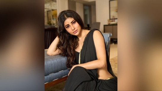With the help of hairstylist Queensly Chettiar, Mouni styled her luscious locks into soft curls, leaving them open at the centre to cascade down her shoulders and complement her chic look.(Instagram/@imouniroy)