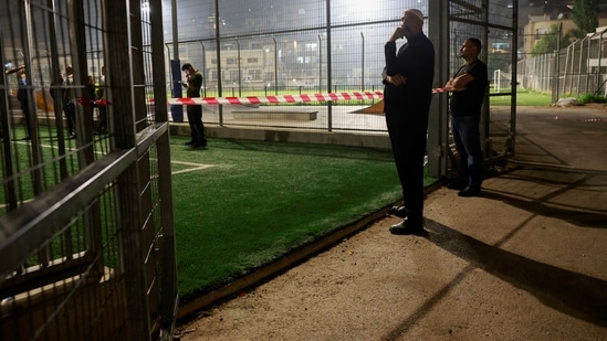 Israeli officials respond after rockets were launched across Lebanon's border with Israel which, according to Israel's ambulance services, people were killed, at a soccer pitch in Majdal Shams, a Druze village in the Israeli-occupied Golan Heights, July 27, 2024. REUTERS/Ammar Awad